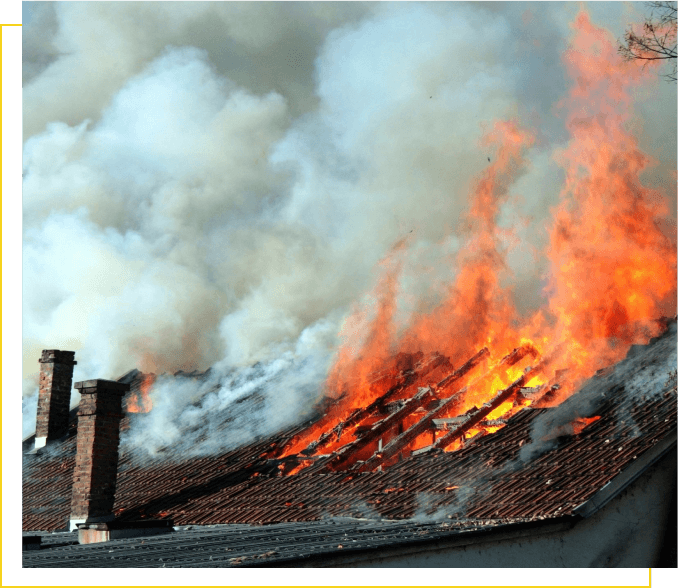 A fire burning on top of a roof.